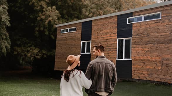 couple in front of a tiny home